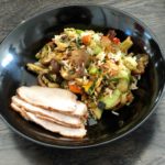 Vegetable fried rice with pork in black bowl